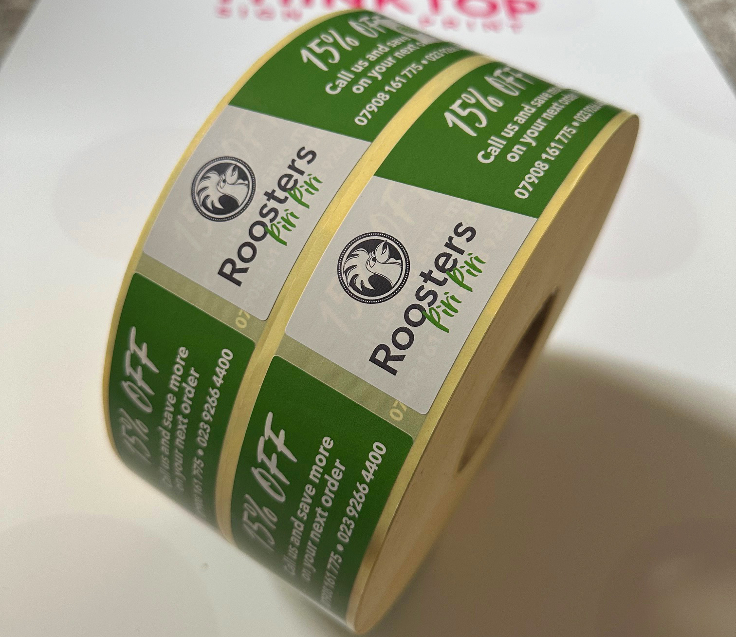Roll of Roosters Piri green and white offer labels